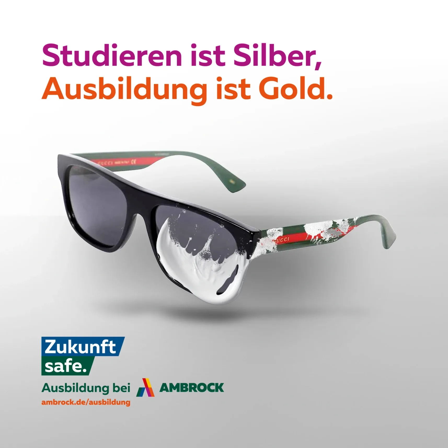 Werbeanzeige: schwarze Brille mit weißer Farbe; Slogan 'Studieren ist Silber, Ausbildung ist Gold'; Logo 'Zukunft safe – Ausbildung bei AMBROCK'